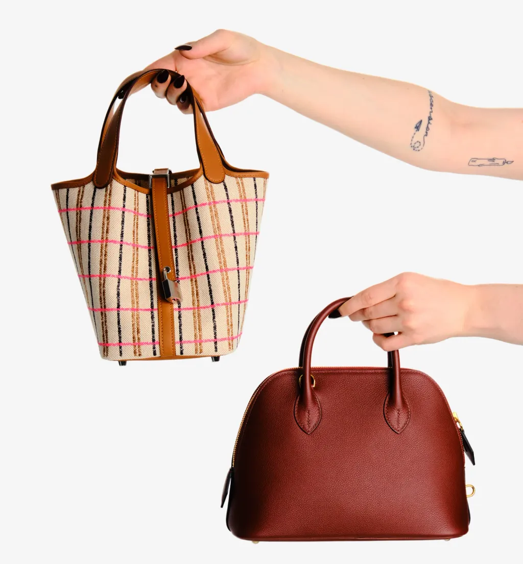 Two authenticated designer handbags held up for inspection